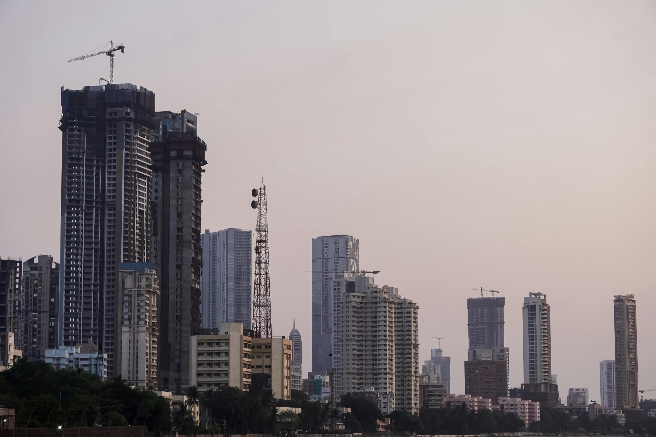 Twilight view of Mumbai's skyline showcasing tall buildings and a serene evening ambiance.
